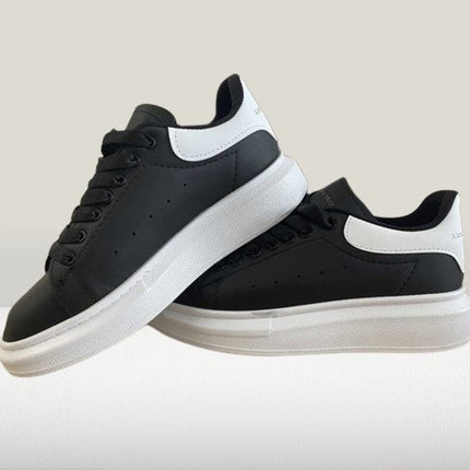 Stylish Alexander McQueen Black sneakers with white accents

